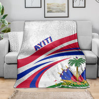 Haiti flag style blanket draped over a sofa, light gray background with blue and red stripes.