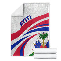 Folded Haiti flag style blanket stack, light gray with blue and red diagonal stripes.