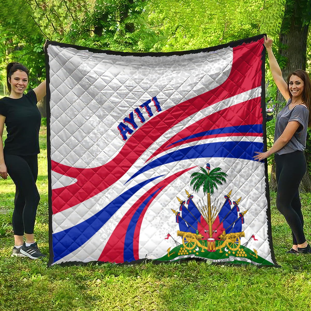 Haiti Independence quilt displayed outdoors, white with red/blue flag curves and 'AYITI'.