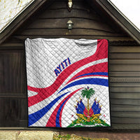 Haiti Independence quilt hanging on a covered porch, white with red/blue flag curves.