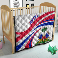 Haiti Independence quilt in a baby bed, white with red/blue flag curves and 'AYITI'.
