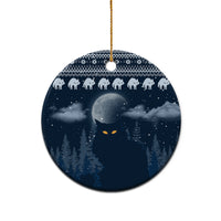 Blue ceramic round Christmas ornament with snowy night forest, cat faces, and gold hanging cord