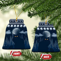Blue ceramic bell-shaped Christmas ornament with snowy night forest, cat faces, and gold hanger