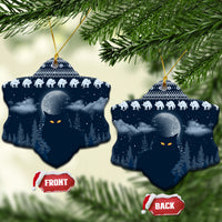 Blue ceramic snowflake-shaped Christmas ornament with snowy night forest, cat faces, and gold hanger