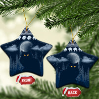 Blue ceramic star-shaped Christmas ornament with snowy night forest, cat faces, and gold hanger