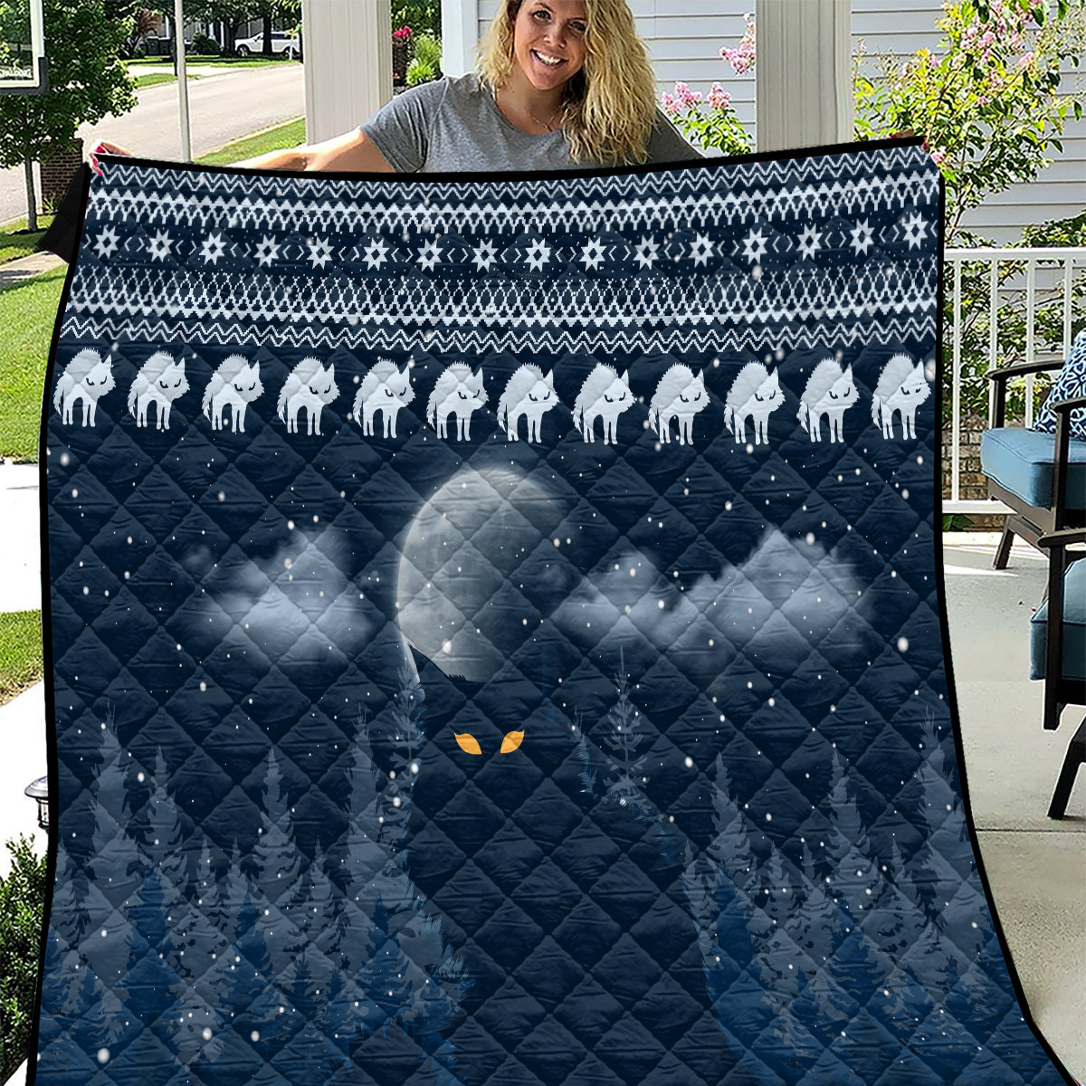 Blue cat Christmas quilt with white cat silhouettes, diamond quilting, and orange eye motifs