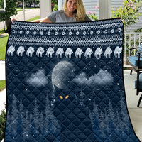 Blue cat Christmas quilt with white cat silhouettes, diamond quilting, and orange eye motifs