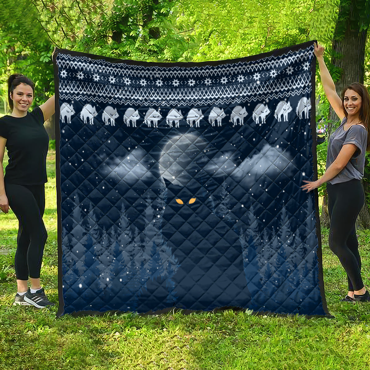 Blue cat Christmas quilt laid flat outdoors, white cat row border and diamond quilting