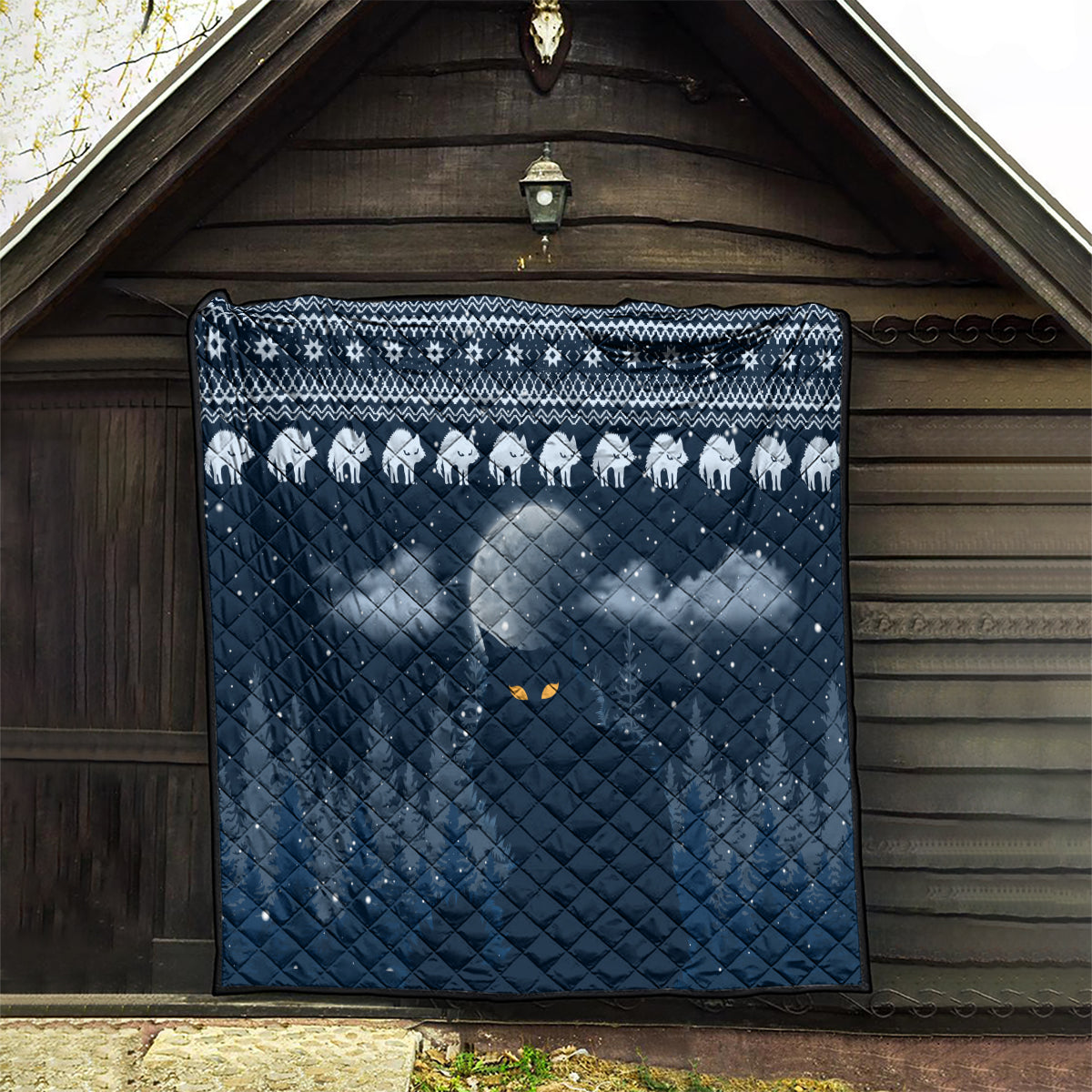 Blue cat Christmas quilt hanging in a barn, white cat silhouettes and diamond quilting