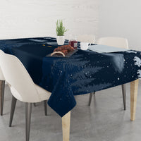 Dark blue tablecloth with snowy night pattern, cat motifs, and draped edge
