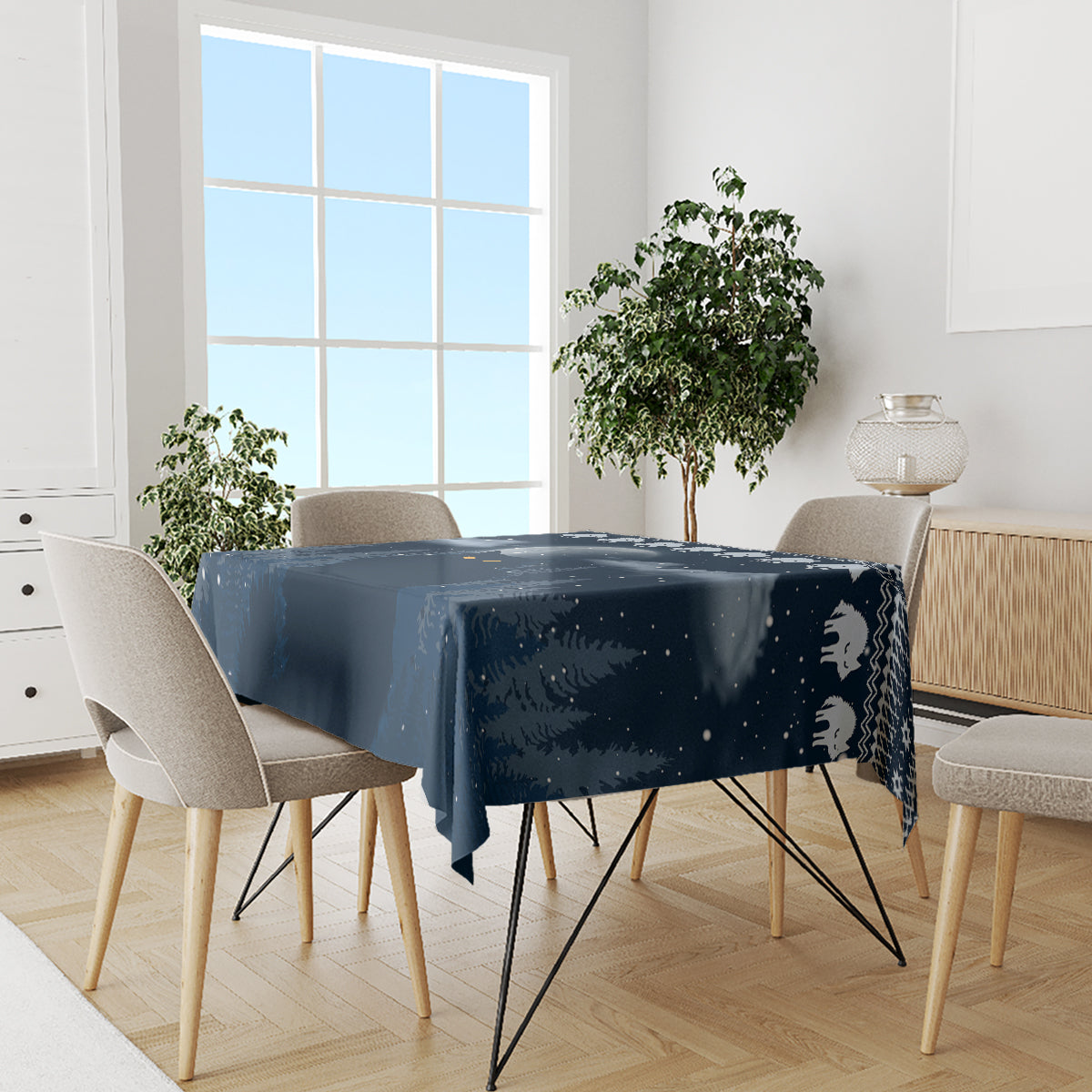 Dark blue tablecloth on dining table with snowy night scene and cat silhouettes
