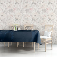Dark blue tablecloth with snowy night artwork and white cats, on a dining table