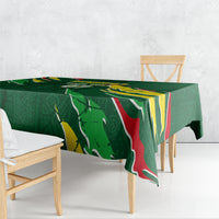 Green football tablecloth draped over wooden bench, with Senegal flag artwork