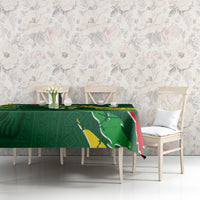 Green football tablecloth on long dining table, Senegal flag design in center