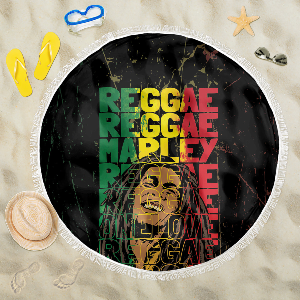 Round black beach blanket with white fringe border and bold colorful reggae text