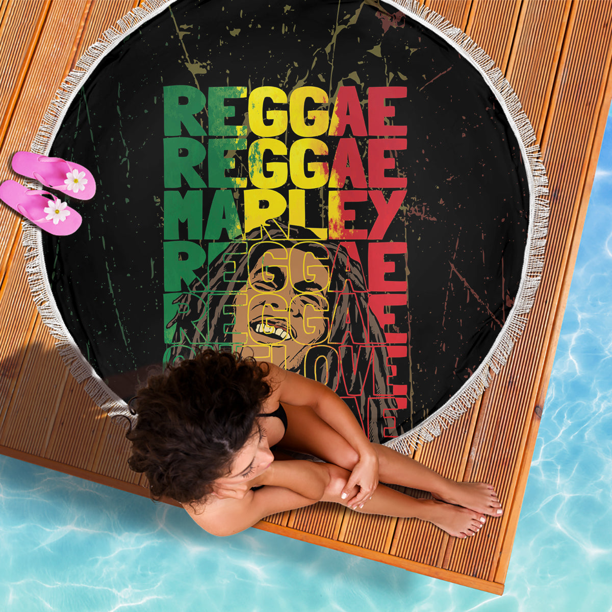 Black round beach blanket with fringed edge, reggae text print in green red yellow
