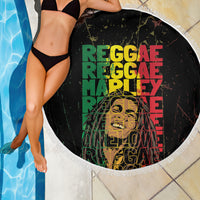 Black round beach blanket with fringed edge, colorful reggae text graphic