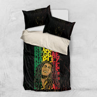 Black bedding set laid flat with grunge 'REGGAE' typography on duvet and pillows