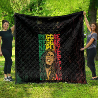 Black quilt laid out flat, featuring stacked green and red REGGAE text with face artwork