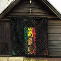 Black quilt displayed with diamond stitching and layered green red REGGAE text with portrait