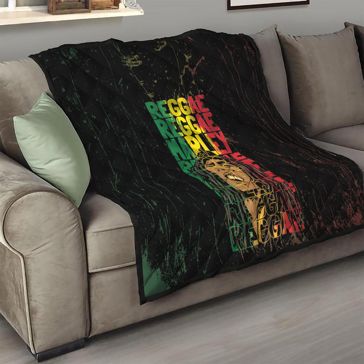 Black quilt with diamond quilting, multicolor REGGAE text, and portrait graphic on sofa