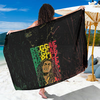 Black reggae-themed sarong with multicolor grunge text graphic, draped fabric