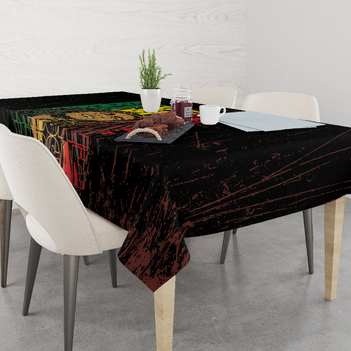 Black tablecloth with grunge reggae word art, corners falling over the table.