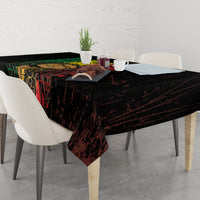 Black tablecloth with grunge reggae word art, corners falling over the table.