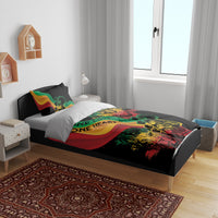 Black duvet and two pillows with colorful reggae “One Love One Heart” graphic