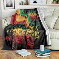Reggae-themed throw blanket, black with green red yellow lion and guitar graphic and “One Love”.