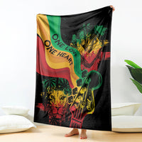 Reggae-themed throw blanket hanging display, black with colorful lion, guitar, and “One Love” text.