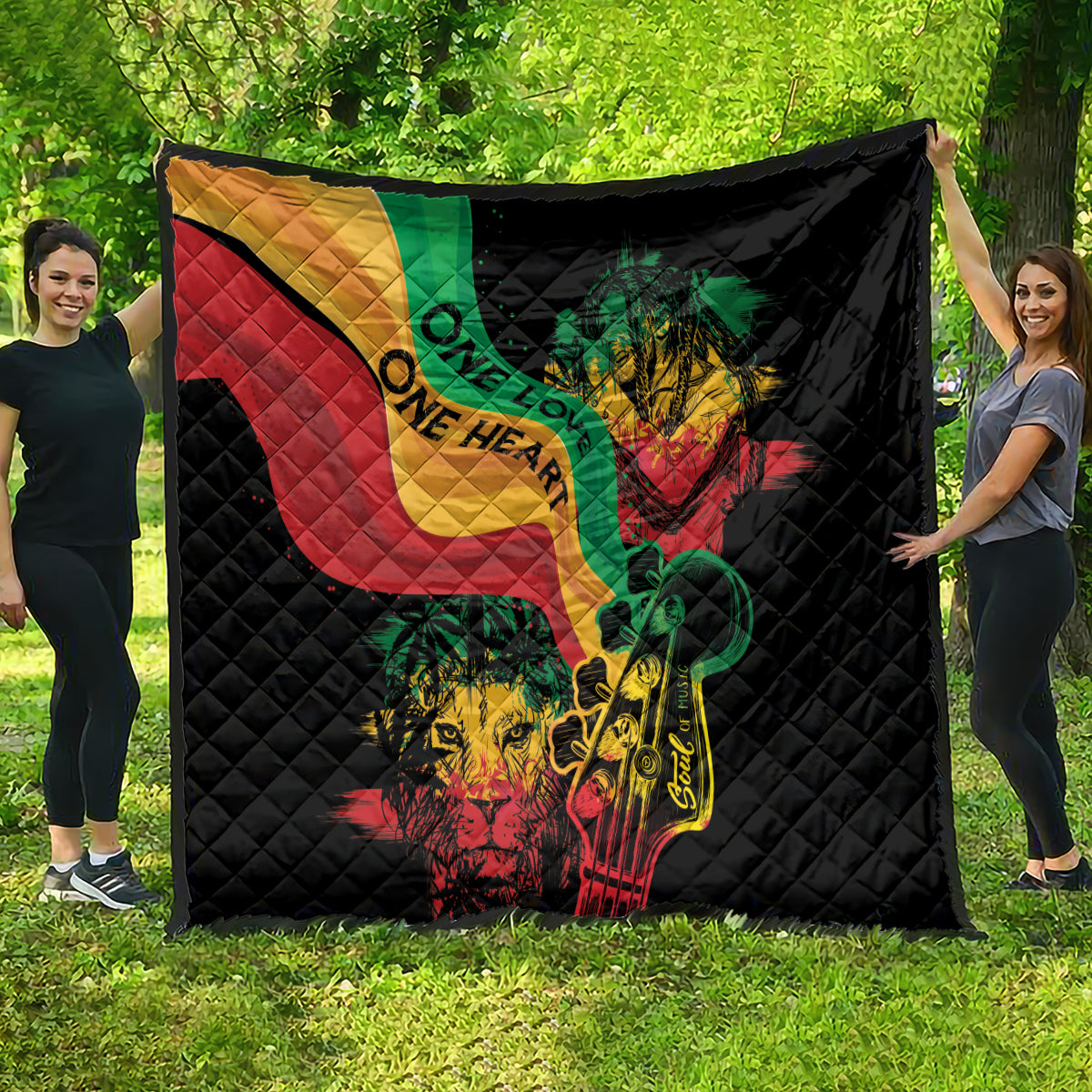 Black quilt blanket with reggae heart, lion and guitar design, large full-width view.