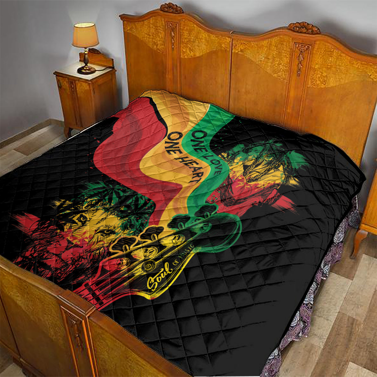 Black quilt on a bed with colorful reggae heart, lion and guitar graphic, quilted diamonds.