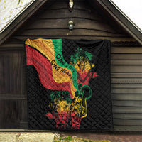 Black quilt blanket with reggae heart, lion and guitar artwork, displayed in a doorway.