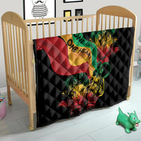 Black quilt on a child bed with colorful reggae heart, lion and guitar artwork, quilted.