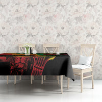 Black rectangular tablecloth with colorful reggae text and heart graphic, draped on a table