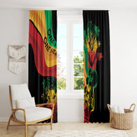 Reggae window curtain panels hanging above floor with lion graphic in red, yellow, green.