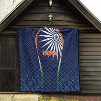 Blue India quilt blanket with sunburst logo and INDIA text, hanging outdoors