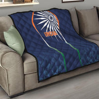 Blue India quilt blanket with sunburst logo and INDIA text, draped on couch