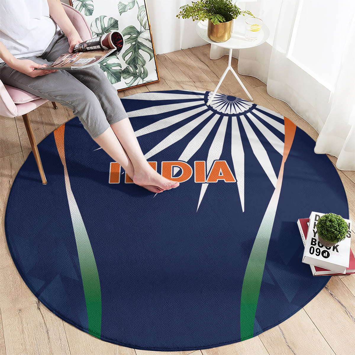 Round blue rug with INDIA logo, starburst rays, and green and orange side stripes