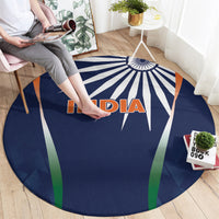 Round blue rug with INDIA logo, starburst rays, and green and orange side stripes