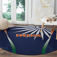 Round blue rug with INDIA text and radial rays, bordered by green and orange accents