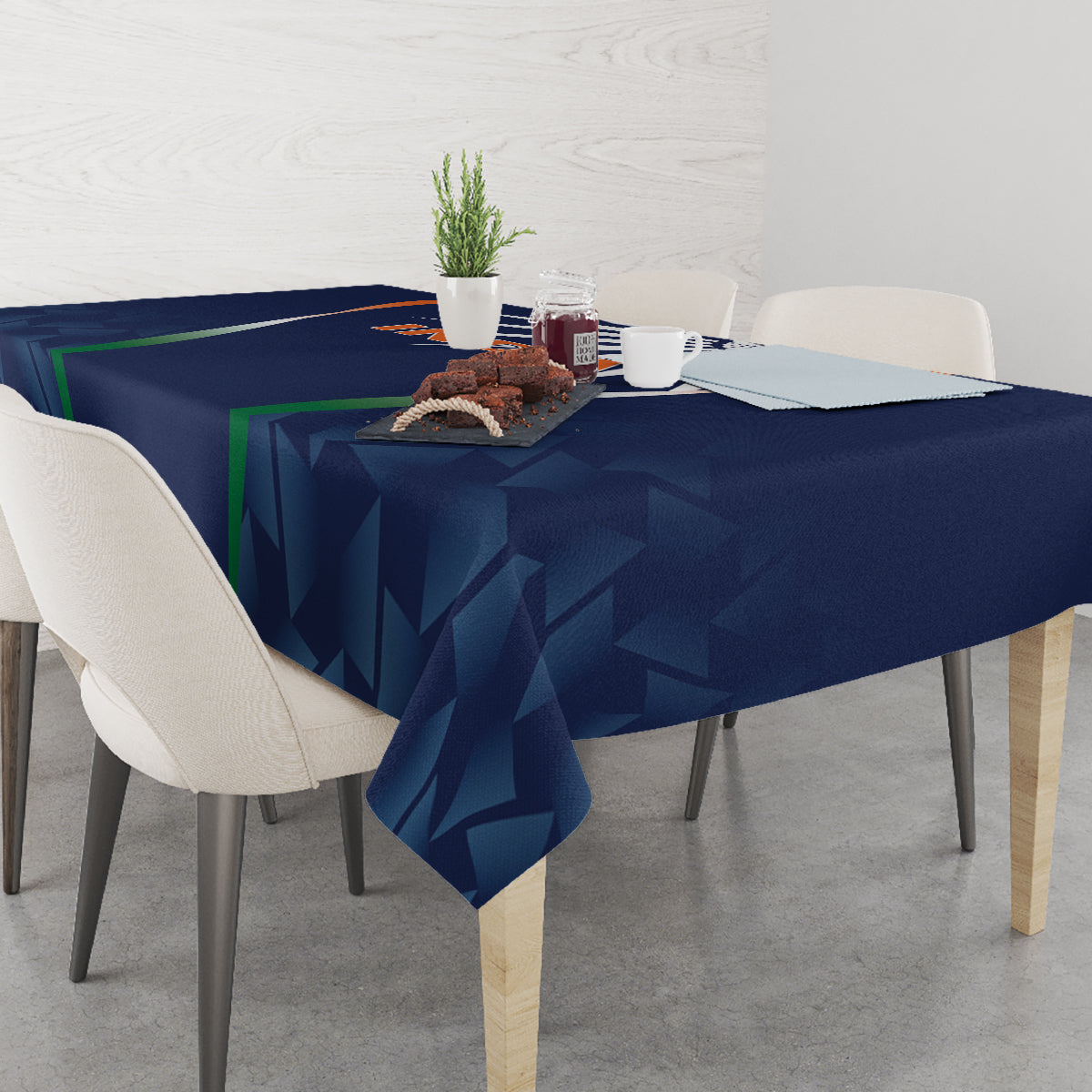 Blue tablecloth draped over dining table with geometric triangles pattern
