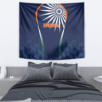 Blue INDIA cricket tapestry on wall above bed, showing emblem and green vertical stripes