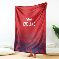 Red England blanket hanging on floor, white England logo and crown-and-lion pattern