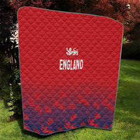 Red quilt blanket with navy patterned bottom and 'ENGLAND' crest emblem, bordered edge.