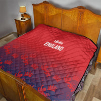 Red England quilt draped on wooden bed frame, diamond stitching and crest logo.