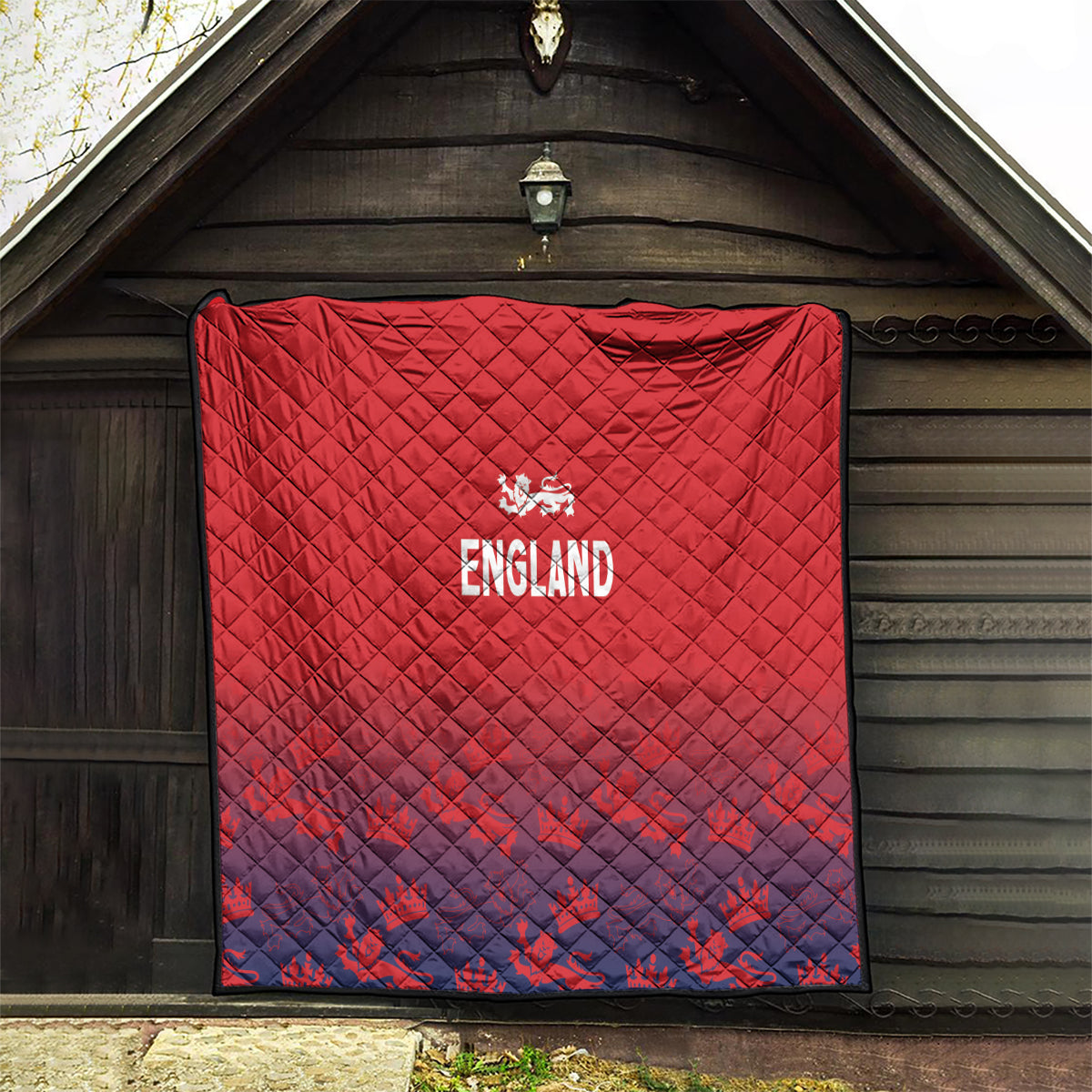 Red and navy England quilt with diamond quilting and crest logo, stitched border.