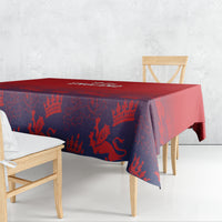 Red and navy patterned tablecloth with overhanging corners on dining table.