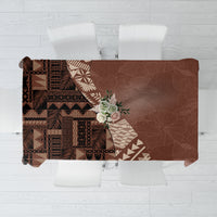 Brown tablecloth with tribal tapa pattern panels and leaf motifs, square-cornered edge